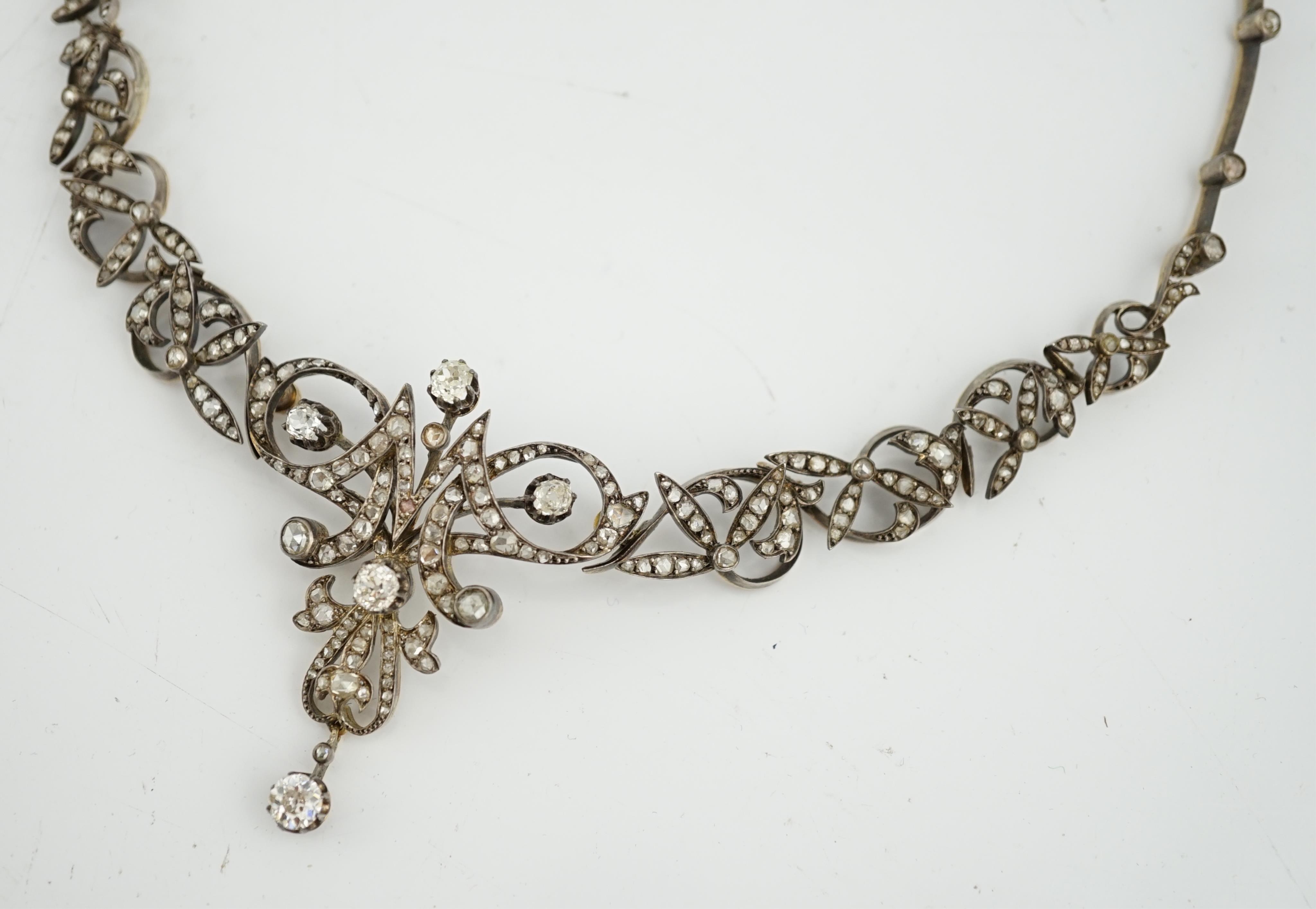 A late 19th/early 20th century French 18ct gold and silver, old mine and rose cut diamond cluster set tiara/necklace